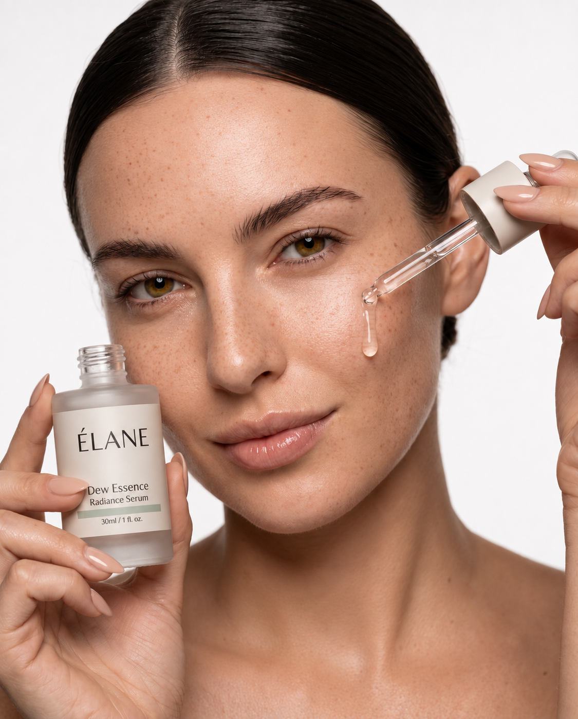 Model holding an ÉLANE Dew Essence radiance serum bottle with a dropper releasing a drop
